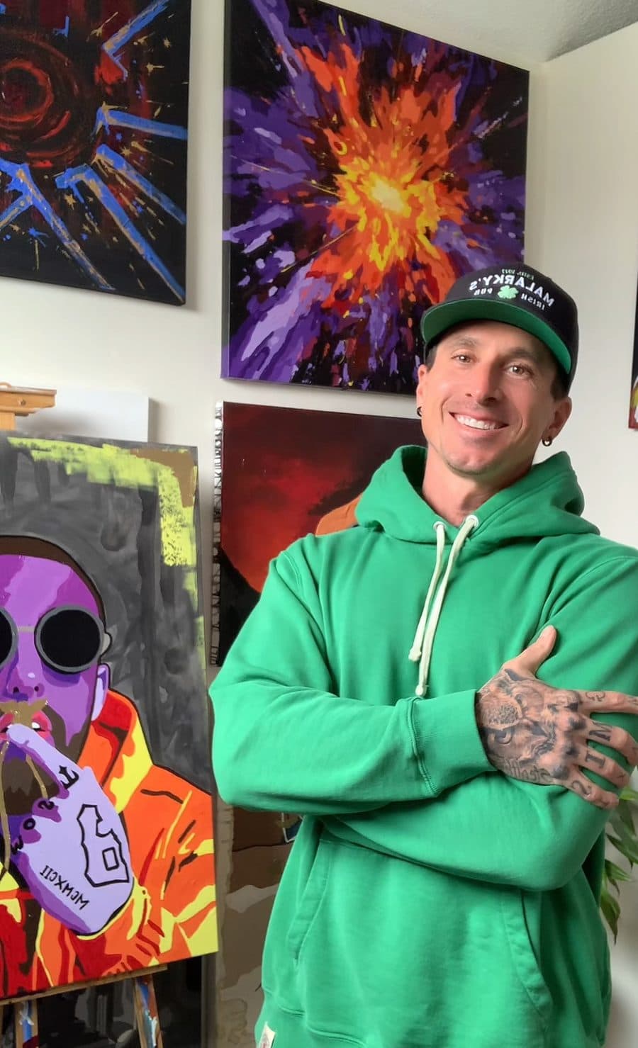 B. Van Sanders in his studio, surrounded by his paintings